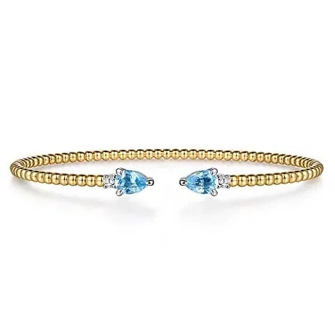 women's charm bracelet -Gabriel & Co. Bujukan Open Cuff Bracelet with Blue Topaz and Diamonds in 14K Yellow and White Gold